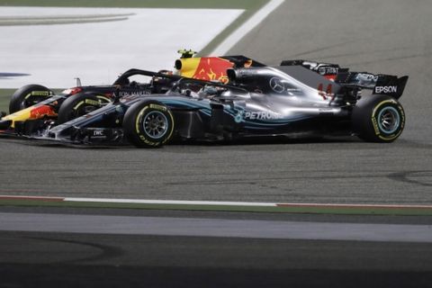 Mercedes driver Lewis Hamilton of Britain and Red Bull driver Max Verstappen of the Netherlands jostling for position during the Bahrain Formula One Grand Prix, at the Formula One Bahrain International Circuit in Sakhir, Bahrain, Sunday, April 8, 2018. (AP Photo/Luca Bruno)