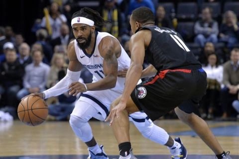 Memphis Grizzlies guard Mike Conley, left, controls the ball against Los Angeles Clippers guard Avery Bradley in the second half of an NBA basketball game Wednesday, Dec. 5, 2018, in Memphis, Tenn. (AP Photo/Brandon Dill)
