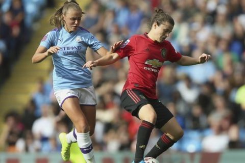 Manchester City's Georgia Stanway, left, and Manchester United's Hayley Ladd battle for the ball during the Women's Super League soccer match at the Etihad Stadium, Manchester, England, Saturday Sept. 7, 2019. (Nigel French/PA via AP)