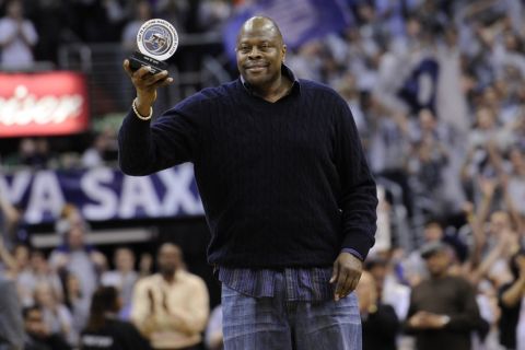 Former NBA and Georgetown basketball player Patrick Ewing acknowledges the crowd after he was recognized with an award during the second half of an NCAA college basketball game between Georgetown and Syracuse, Saturday, March 9, 2013, in Washington. Georgetown won 61-39. (AP Photo/Nick Wass)