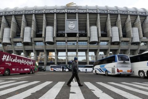 A man walks outside of the Santiago Bernabeu stadium in Madrid, Spain, Friday, Nov. 30, 2018. The twice-postponed Copa Libertadores final between Argentina archrivals Boca Juniors and River Plate will be played in Madrid on Dec. 9. The second leg was supposed to be played last Saturday, but Boca players were injured when their bus was attacked by River fans. (AP Photo/Manu Fernandez)