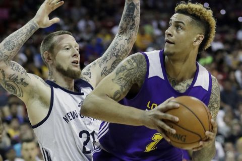 Los Angeles Lakers' Zach Auguste drives into New Orleans' Nick Minnerath during the second half of an NBA summer league basketball game, Friday, July 8, 2016, in Las Vegas. (AP Photo/John Locher)