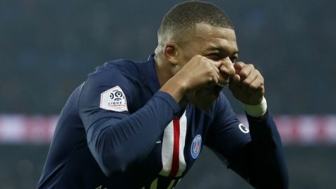PSG's Kylian Mbappe celebrates after scoring his side goal during the French League One soccer match between PSG and Marseille at the Parc des Princes stadium in Paris, France, Sunday, Oct. 27, 2019. (AP Photo/Kamil Zihnioglu)