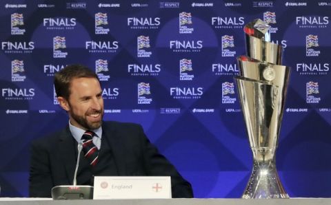 England soccer manager Gareth Southgate looks at the Nations League Trophy during the UEFA Nations League Finals draw at the Shelbourne Hotel, Dublin, Monday Dec. 3, 2018. (Niall Carson/PA via AP)
