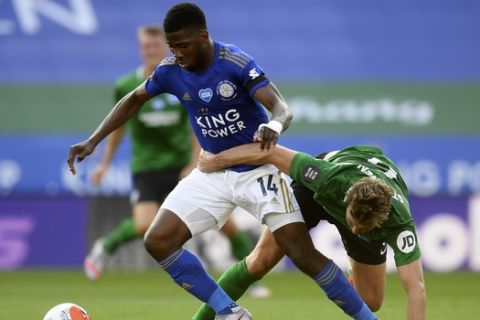 Brighton's Dale Stephens, right, tries to stop Leicester's Kelechi Iheanacho during the English Premier League soccer match between Leicester City and Brighton & Hove Albion at the King Power Stadium, in Leicester, England, Tuesday, June 23, 2020. (Michael Regan/Pool via AP)
