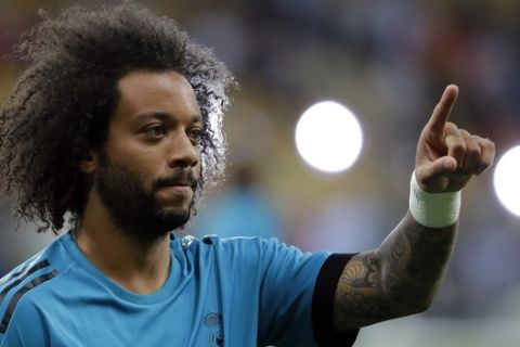 Real Madrid's Marcelo points as he warms up ahead of the Champions League Final soccer match between Real Madrid and Liverpool at the Olimpiyskiy Stadium in Kiev, Ukraine, Saturday, May 26, 2018. (AP Photo/Sergei Grits)