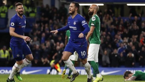 Chelsea's Eden Hazard, center, celebrates after scoring his sides second goal during the English Premier League soccer match between Chelsea and Brighton & Hove Albion at Stamford Bridge stadium in London, Wednesday, April 3, 2019. (AP Photo/Frank Augstein)