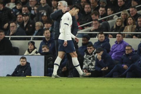 Tottenham's Son Heung-min is consoled by Tottenham's manager Jose Mourinho as he leaves the pitch after getting a red card, during the English Premier League soccer match between Tottenham Hotspur and Chelsea, at the Tottenham Hotspur Stadium in London, Sunday, Dec. 22, 2019. (AP Photo/Ian Walton)