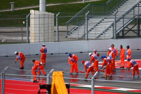 SOCHI, RUSSIA - OCTOBER 09:  Marshalls clean the track as the session is delayed following a fuel leak on track during practice for the Formula One Grand Prix of Russia at Sochi Autodrom on October 9, 2015 in Sochi, Russia.  (Photo by Clive Mason/Getty Images)