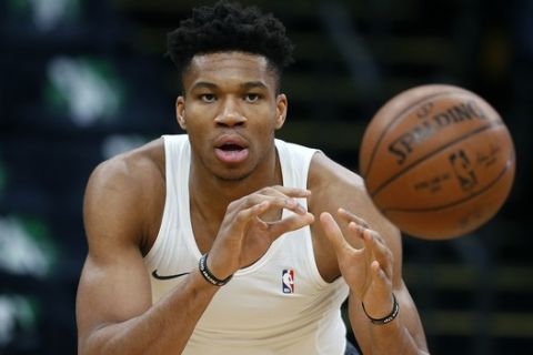 Milwaukee Bucks' Giannis Antetokounmpo warms up before Game 3 of a second round NBA basketball playoff series against the Boston Celtics in Boston, Friday, May 3, 2019. (AP Photo/Michael Dwyer)