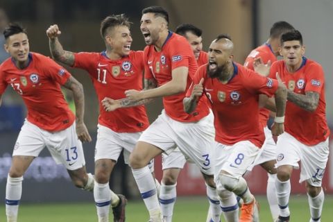 Chile's players, from left to right, Esteban Pavez, Arturo Vidal, Guillermo Maripan, Eduardo Vargas and Erick Pulgar celebrate beating Colombia 5-4 in a penalty kick shoot-out in a Copa America quarterfinal soccer match at the Arena Corinthians in Sao Paulo, Brazil, Friday, June 28, 2019. Chile qualified to the semifinals of the South American soccer tournament. (AP Photo/Andre Penner)