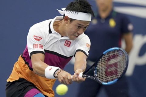 Kei Nishikori, of Japan, returns a shot to Bradley Klahn, of the United States, during the second round of the US Open tennis championships Wednesday, Aug. 28, 2019, in New York. (AP Photo/Michael Owens)