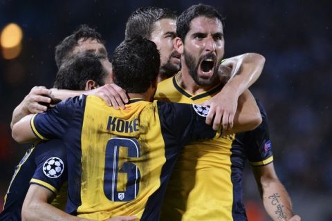 Atletico Madrid's midfielder Raul Garcia (R) celebrates with his teammates after scoring during the UEFA Champions League second-leg Group A football match Malmo FF vs Club Atletico de Madrid in Malmo, Sweden on November 4, 2014. Madrid won the match 0-2. AFP PHOTO / JONATHAN NACKSTRAND        (Photo credit should read JONATHAN NACKSTRAND/AFP/Getty Images)