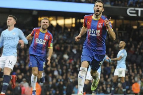 Crystal Palace's Luka Milivojevic celebrates with his teammates after scoring his side's third goal during the English Premier League soccer match between Manchester City and Crystal Palace at Etihad stadium in Manchester, England, Saturday, Dec. 22, 2018. (AP Photo/Rui Vieira)