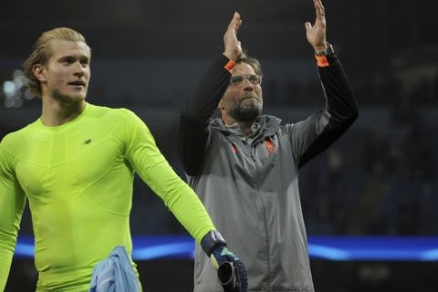 Liverpool manager Juergen Klopp and Liverpool goalkeeper Loris Karius celebrate in front of their side's fans after they won the Champions League quarterfinal second leg soccer match between Manchester City and Liverpool at Etihad stadium in Manchester, England, Tuesday, April 10, 2018. (AP Photo/Rui Vieira)
