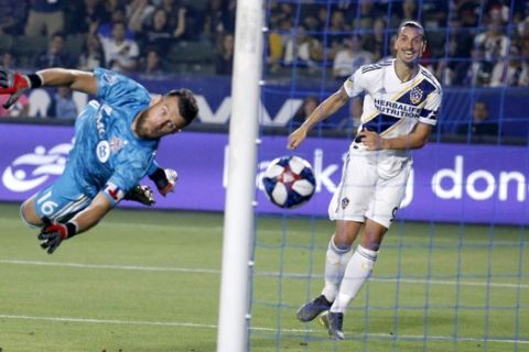 LA Galaxy forward Zlatan Ibrahimovic, right, scores on Toronto FC goalkeeper Quentin Westberg during the second half of an MLS soccer match in Carson, Calif., Thursday, July 4, 2019. The Galaxy won 2-0. (AP Photo/Ringo H.W. Chiu)