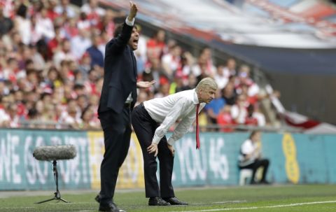 Chelsea team manager Antonio Conte, let, shouts as Arsenal team manager Arsene Wenger watches during the English FA Cup final soccer match between Arsenal and Chelsea at the Wembley stadium in London, Saturday, May 27, 2017. (AP Photo/Matt Dunham)
