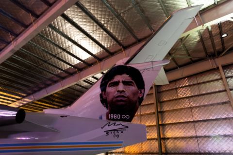 View of an aircraft called Tango D10S painted with images depicting Argentine late football star Diego Armando Maradona, during its presentation in Moron, Buenos Aires province, Argentina, on May 25, 2022. - Some of the 1986 FIFA World Cup champions will travel to the Qatar FIFA World Cup on November, 2022 in the Tango D10S to pay homage to Maradona. (Photo by Tomas CUESTA / AFP)