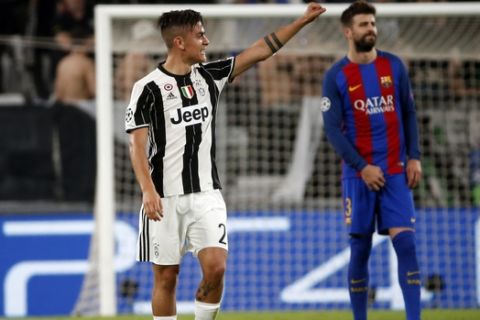 Juventus's Paulo Dybala celebrates after scoring his side's second goal during a Champions League, quarterfinal, first-leg soccer match between Juventus and Barcelona, at the Juventus Stadium in Turin, Italy, Tuesday, April 11, 2017. (AP Photo/Antonio Calanni)