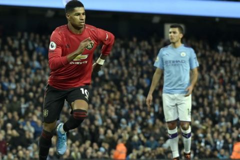 Manchester United's Marcus Rashford celebrates after scoring his side's opening goal from the penalty spot during the English Premier League soccer match between Manchester City and Manchester United at Etihad stadium in Manchester, England, Saturday, Dec. 7, 2019. (AP Photo/Rui Vieira)