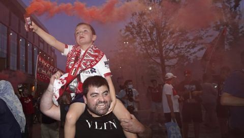 Liverpool supporters celebrate as they gather outside of Anfield Stadium in Liverpool, England, Thursday, June 25, 2020 after Liverpool clinched the English Premier League title. Liverpool took the title after Manchester City failed to beat Chelsea on Wednesday evening. (AP photo/Jon Super)