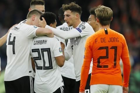 Germany's Serge Gnabry, third from left, celebrates with his teammates after scoring his side's second goal during the Euro 2020 group C qualifying soccer match between Netherlands and Germany at the Johan Cruyff ArenA in Amsterdam, Sunday, March 24, 2019. (AP Photo/Peter Dejong)