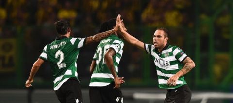 Sporting's Brazilian midfielder Bruno Cesar (R) celebrates with his teammate Sporting's Italian defender Matias Schelotto (L) after scoring during the UEFA Champions League football match Sporting CP vs BVB Borussia Dortmund at the Jose Alvalade stadium in Lisbon on October 18, 2016. / AFP / PATRICIA DE MELO MOREIRA        (Photo credit should read PATRICIA DE MELO MOREIRA/AFP/Getty Images)