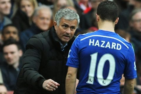 Chelsea manager Jose Mourinho speaks to his player Eden Hazard during the English Premier League soccer match between Arsenal and Chelsea at the Emirates Stadium, London, England, Sunday, April 26, 2015. (AP Photo/Rui Vieira)