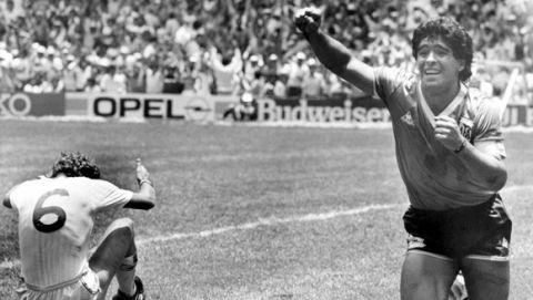 Argentina's Diego Maradona runs across the soccer field in jubilation after he had scored his second goal against England in the World Cup quarter final, in Mexico City, Mexico, on June 22, 1986. England's Terry Butcher sits on the floor. (AP Photo)