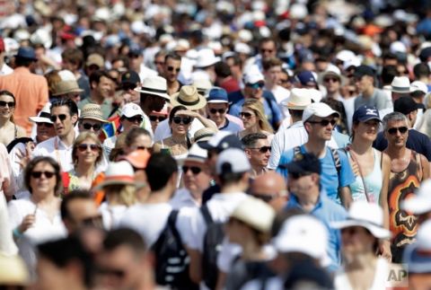 In this Sunday, May 28, 2017 photo, spectators walk the stadium grounds during first round matches of the French Open tennis tournament at the Roland Garros stadium in Paris, France. (AP Photo/Petr David Josek)