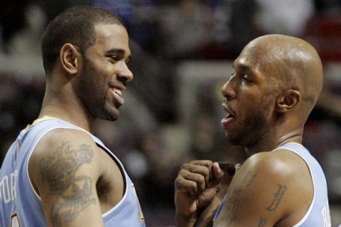 Denver Nuggets' Chauncey Billups, right, celebrates with Gary Forbes in the fourth quarter after sinking one of his six 3-points baskets in an NBA basketball game against the Detroit Pistons on Wednesday, Jan. 26, 2011, in Auburn Hills, Mich. Billups led the Nuggets with 26 points in their 109-100 win. (AP Photo/Duane Burleson)