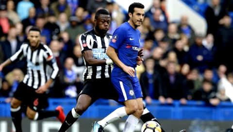 Chelsea's Pedro, right, challenges for the ball with Newcastle United's Chancel Mbemba during the English FA Cup fourth round soccer match between Chelsea and Newcastle United at Stamford Bridge stadium in London, Sunday, Jan. 28, 2018 . (AP Photo/Alastair Grant)