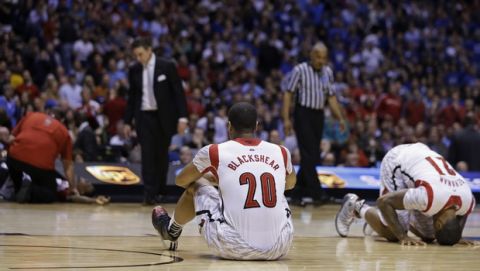 Louisville's Wayne Blackshear (20) and Chane Behanan (21) react to Kevin Ware's injury during the first half of the Midwest Regional final in the NCAA college basketball tournament, Sunday, March 31, 2013, in Indianapolis. (AP Photo/Darron Cummings)