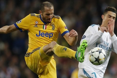 Real Madrid's Cristiano Ronaldo, right, is challenged by Juventus' Giorgio Chiellini during a Champions League quarter-final, 2nd leg soccer match between Real Madrid and Juventus at the Santiago Bernabeu stadium in Madrid, Spain, Wednesday, April 11, 2018. (AP Photo/Paul White)