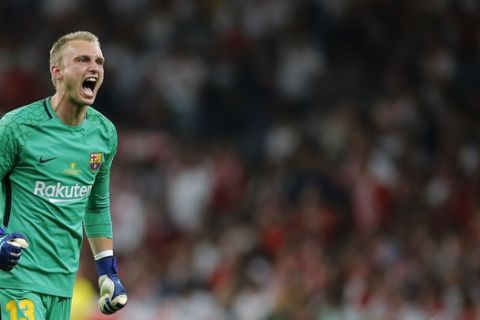 Barcelona goalkeeper Jasper Cillessen celebrates after Luis Suarez scoring his side's opening goal during the Copa del Rey final soccer match between Barcelona and Sevilla at the Wanda Metropolitano stadium in Madrid, Spain, Saturday, April 21, 2018. (AP Photo/Paul White)