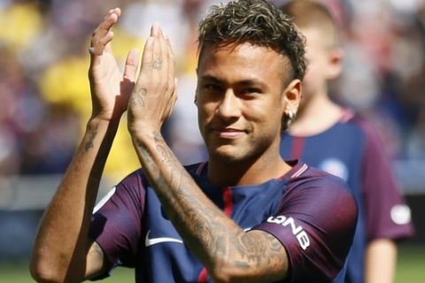 Brazilian soccer star Neymar applauds his fans at the Parc des Princes stadium in Paris, Saturday, Aug. 5, 2017, during his official presentation to fans ahead of Paris Saint-Germain's season opening match against Amiens. Neymar would not play in the club's season opener as the French football league did not receive the player's international transfer certificate before Friday's night deadline. The Brazil star became the most expensive player in soccer history after completing his blockbuster transfer from Barcelona for 222 million euros ($262 million) on Thursday. (AP Photo/Francois Mori)