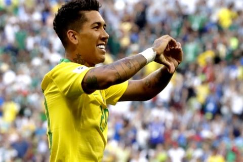 Brazil's Roberto Firmino celebrates after scoring his side's second goal during the round of 16 match between Brazil and Mexico at the 2018 soccer World Cup in the Samara Arena, in Samara, Russia, Monday, July 2, 2018. (AP Photo/Andre Penner)