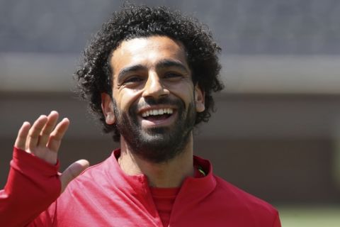 Liverpool forward Mohamed Salah waves to fans before a training session, Friday, July 27, 2018, in Ann Arbor, Mich. Liverpool FC will play Manchester United on Saturday in an International Champions Cup tournament soccer match. (AP Photo/Carlos Osorio)