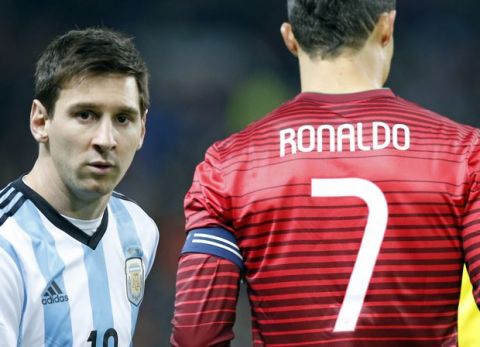 Lionel Messi of Argentina, left, stands next to Cristiano Ronaldo of Portugal before their International Friendly soccer match at Old Trafford Stadium, Manchester, England, Tuesday Nov. 18, 2014. (AP Photo/Jon Super)  