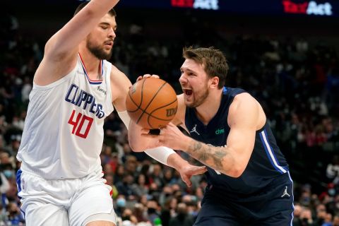 Dallas Mavericks guard Luka Doncic (77) tries to get past Los Angeles Clippers center Ivica Zubac (40) during the second half of an NBA basketball game in Dallas, Saturday, Feb. 12, 2022. (AP Photo/LM Otero)