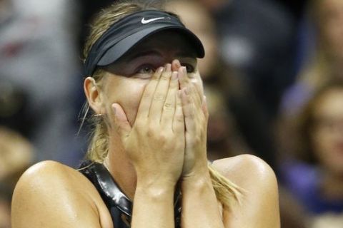 Maria Sharapova reacts after defeating second seed Simona Halep of Romania, 6-4, 4-6, 6-3 in their opening round match in the U.S. Open tennis tournament in New York, Monday, Aug. 28, 2017. (AP Photo/Kathy Willens)