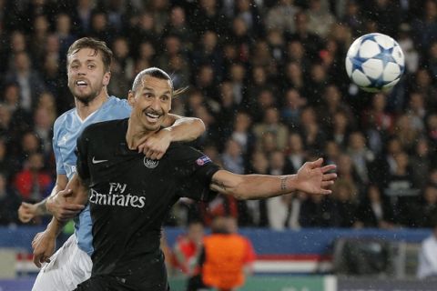 PSG's Zlatan Ibrahimovic, right, and Malmo's Kari Arnason watch the ball during the Champions League Group A soccer match between PSG and Malmo at the Parc des Princes stadium in Paris, France, Tuesday, Sept. 15, 2015. (AP Photo/Thibault Camus)