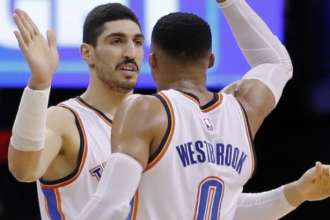 Oklahoma City Thunder center Enes Kanter, left, and Oklahoma City Thunder guard Russell Westbrook, right, high five after a play against the Utah Jazz in the second half of an NBA basketball game in Oklahoma City, Tuesday, Feb. 28, 2017. Oklahoma City won 109-106. (AP Photo/Alonzo Adams)