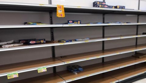 Empty shelves are seen in a supermarket in Rozzano, near Milan, Sunday, Feb. 23, 2020, as fears rapidly spread in Northern Italy with a sudden surge of COVID-19 cases. A dozen Italian towns saw daily life disrupted after the deaths of two people infected with the virus from China and a pair of case clusters without direct links to the outbreak abroad. A rapid spike in infections prompted authorities in the northern Lombardy and Veneto regions to close schools, businesses and restaurants and to cancel sporting events and Masses. (AP Photo/Antonio Calanni)