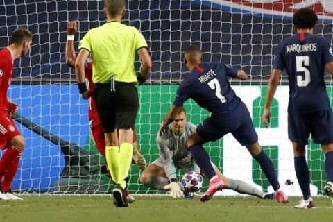 PSG's Kylian Mbappe, centre, shoots on goal during the Champions League final soccer match between Paris Saint-Germain and Bayern Munich at the Luz stadium in Lisbon, Portugal, Sunday, Aug. 23, 2020.(Matthew Childs/Pool via AP)