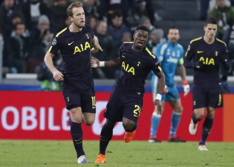Tottenham's Harry Kane, left, celebrates with teammate Serge Aurier after scoring his side's opening goal during the Champions League, round of 16, first-leg soccer match between Juventus and Tottenham Hotspurs, at the Allianz Stadium in Turin, Italy, Tuesday, Feb. 13, 2018. (AP Photo/Antonio Calanni)