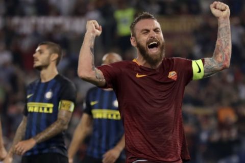 Roma's Daniele De Rossi celebrates after his teammate Kostas Manolas scored during a Serie A soccer match between Roma and Inter Milan, at Rome's Olympic Stadium, Sunday, Oct. 2, 2016. (AP Photo/Andrew Medichini)