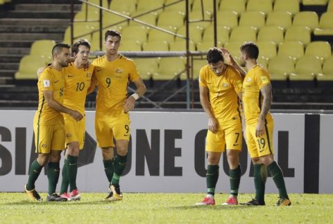Australia's Robbie Kruse, second from left, celebrate with teammate after scoring the first goal during the 2018 World Cup qualifying soccer match between Syria and Australia at the Hang Jebat Stadium in Melaka, Malaysia, Thursday, Oct. 5, 2017. (AP Photo/Vincent Thian)