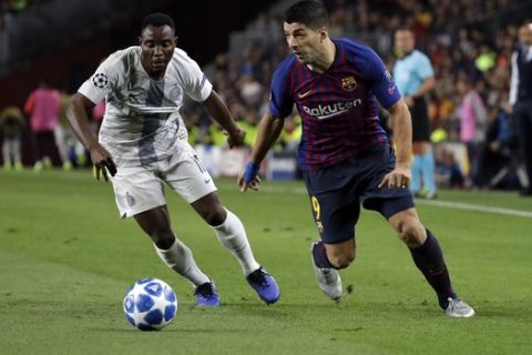 Barcelona forward Luis Suarez, right, controls the ball as Inter defender Kwadwo Asamoah defends during the Champions League, group B soccer match between Barcelona and Inter Milan, at the Nou Camp in Barcelona, Spain, Wednesday, Oct. 24, 2018. (AP Photo/Emilio Morenatti)