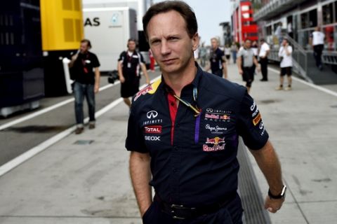 Team principal Christian Horner of Red Bull walks in the paddock prior to the start of  Formula One Hungarian Grand Prix on the Hungaroring circuit near Budapest, Hungary, Sunday, July 27, 2014. (AP Photo/MTI, Janos Marjai)